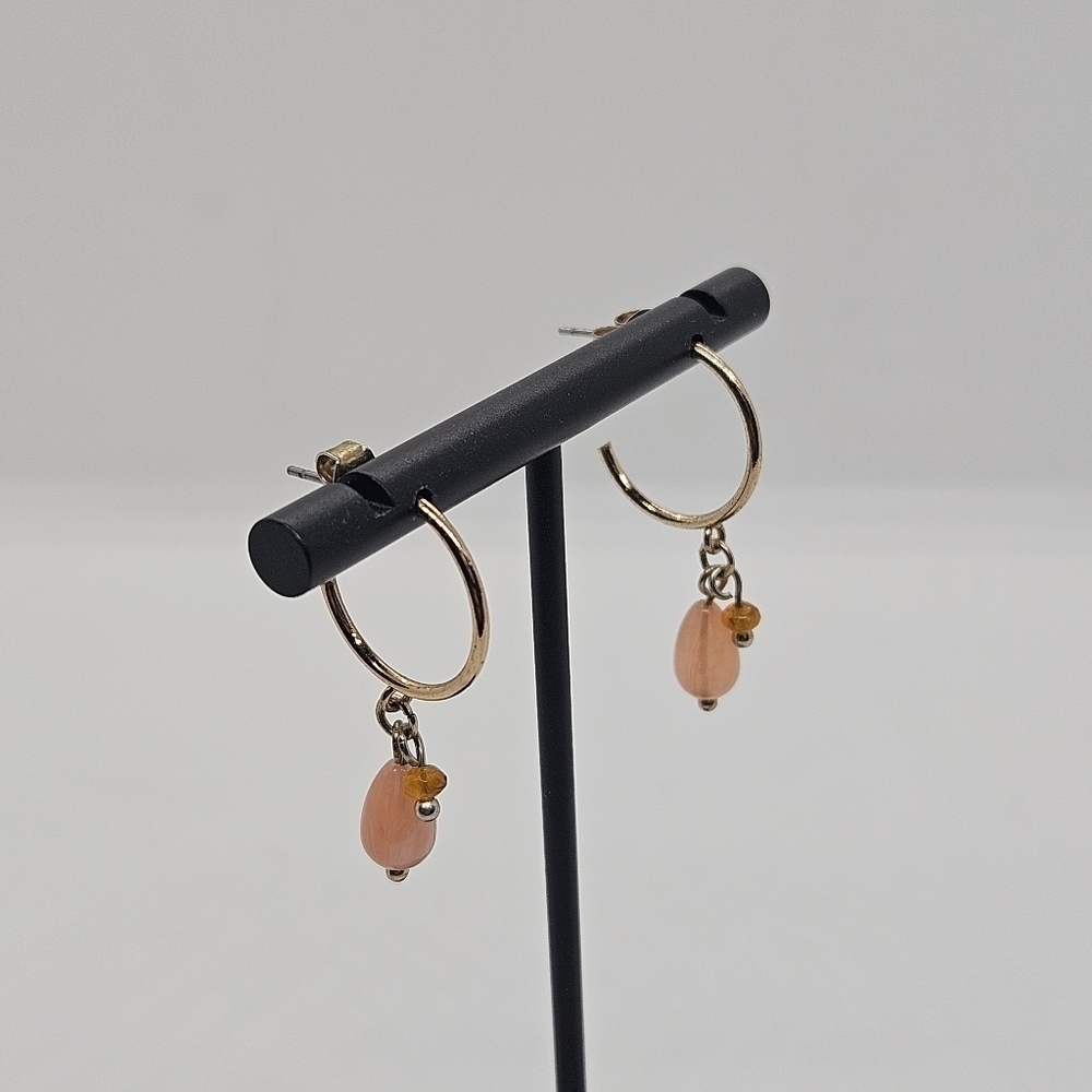 small gold tone hoop earrings with pink and orange beads